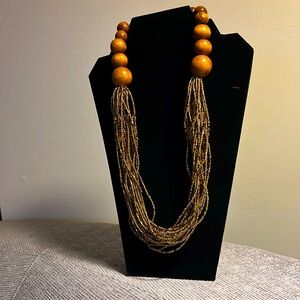 Beaded beauty. Wooden and glass beads in a subtle brozen shade.